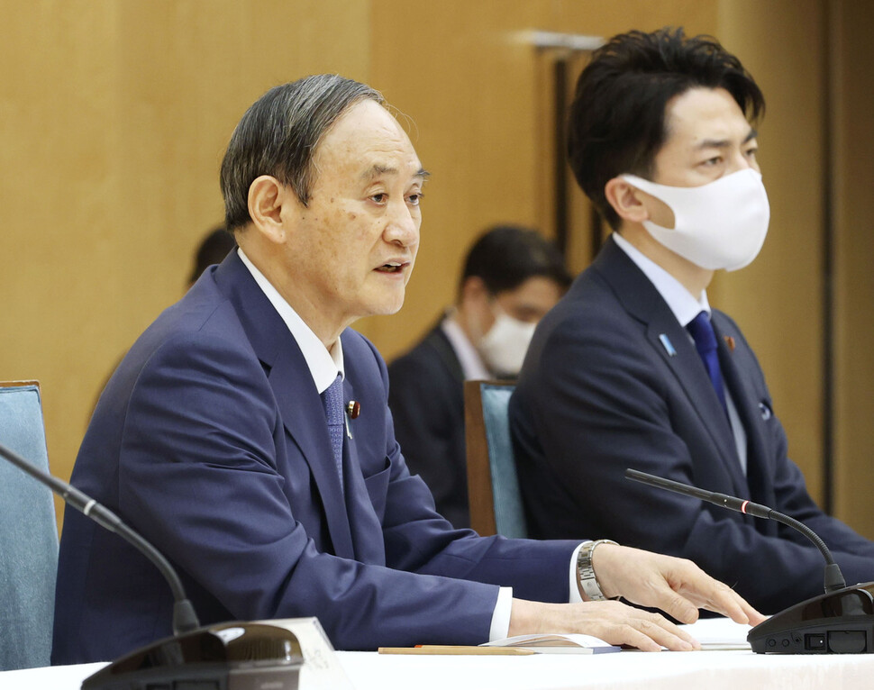 스가 요시히데(왼쪽) 일본 총리가 2021년 4월 22일 일본 도쿄에서 열린 지구온난화 방지 정부 대책회의에 참석해 2030년까지 온실가스 배출량을 2013년도 대비 46% 줄이겠다는 일본의 방침을 밝혔다. 이 목표는 일본의 26% 인하 약속에 비해 크게 증가한 것이다. 오른쪽은 고이즈미 신지로 환경상. 교도뉴스/연합뉴스
