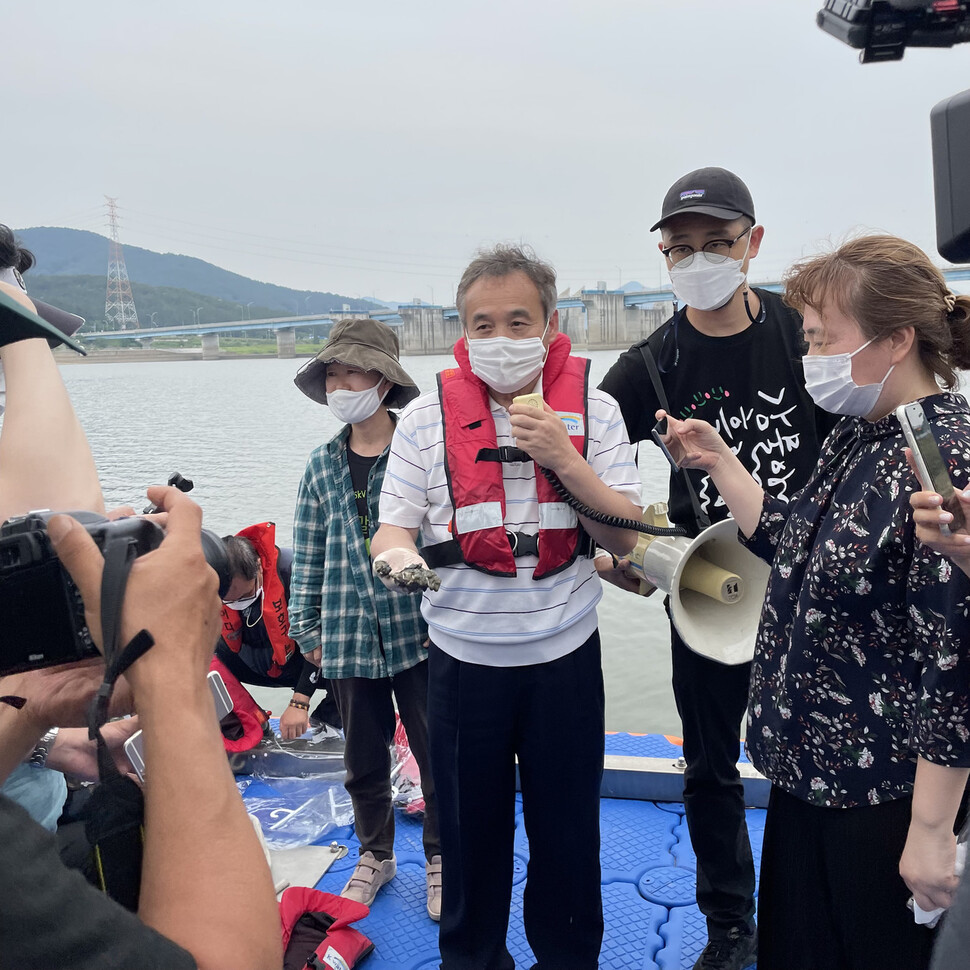 ‘2021 낙동강 종합 건강 진단’팀의 단장인 박창근 가톨릭관동대 교수가 10일 오후 함안보 근처에서 채취한 흙에 관해 설명하고 있다. 환경운동연합 제공
