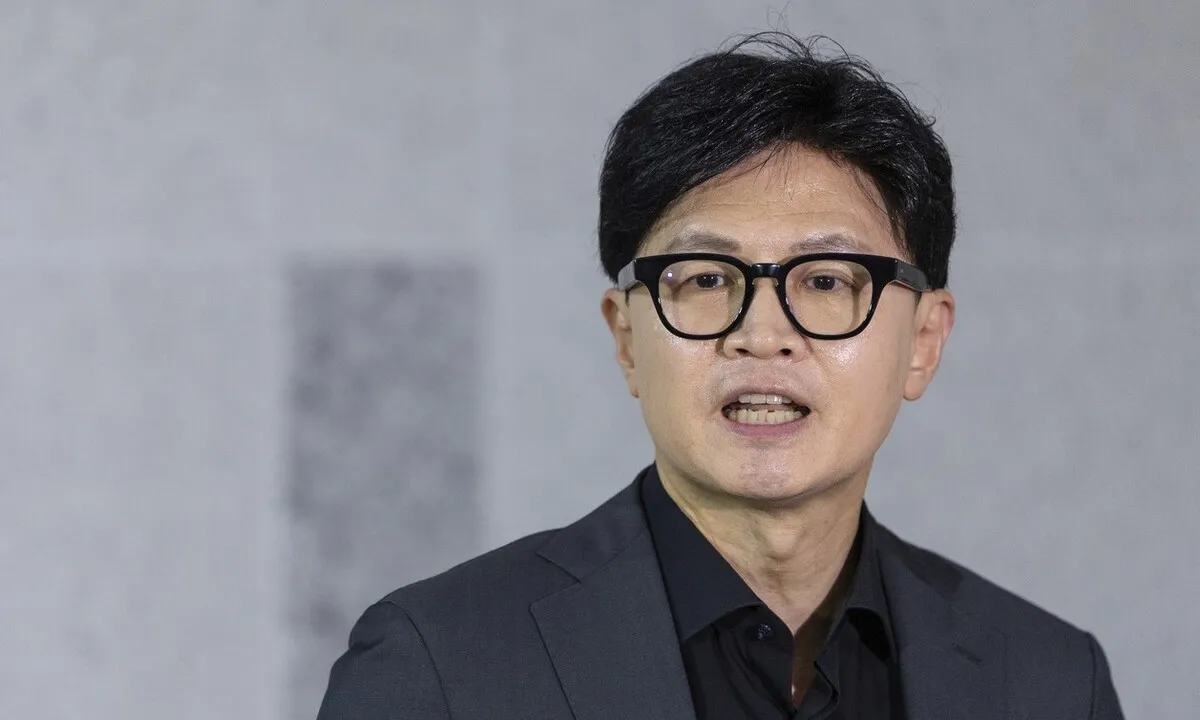 Han Dong-hoon speaking to reporters at the National Assembly