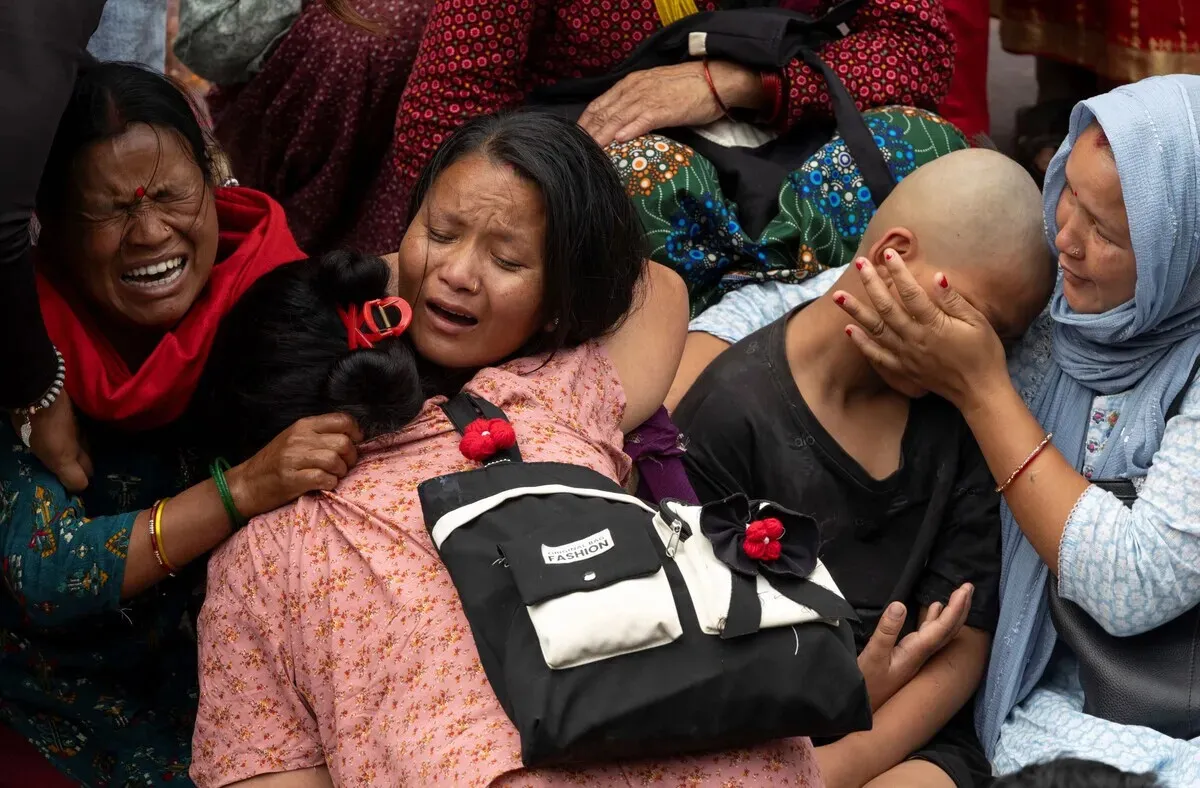 Grieving family members mourn near a cremation ground in Kathmandu, Nepal, following severe climate-induced flash floods and landslides on Sept. 18, 2026. (EPA/Yonhap)