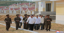 Kim Jong-un visits village rebuilt by N. Korean army that was destroyed by floods and typhoon winds