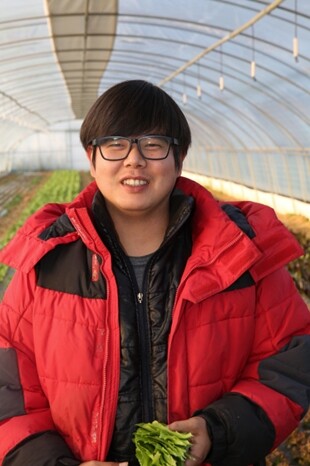 ‘젊은 농부’ 정영환(33)씨가 충남 홍성군 오미마을 젊은협업농장에서 유기농 쌈채소를 수확한 뒤 웃어 보이고 있다. 류우종 기자