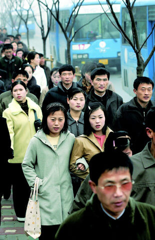  North Korean workers make their way to work.