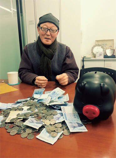 2013년 돼지저금통에 모은 돈을 아름다운재단에 들고 온 김태수씨.아름다운재단 제공