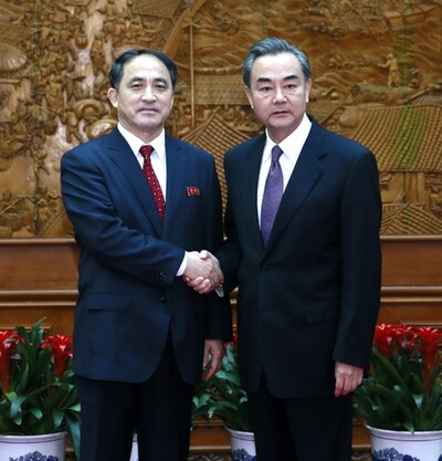 North Korean Vice Foreign Minister Ri Kil-song (left) shakes hands with Chinese Foreign Minister Wang Yi at the Chinese Foreign Ministry in Beijing