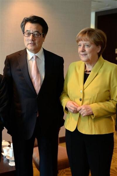 German Chancellor Angela Merkel meets with Katsuya Okada