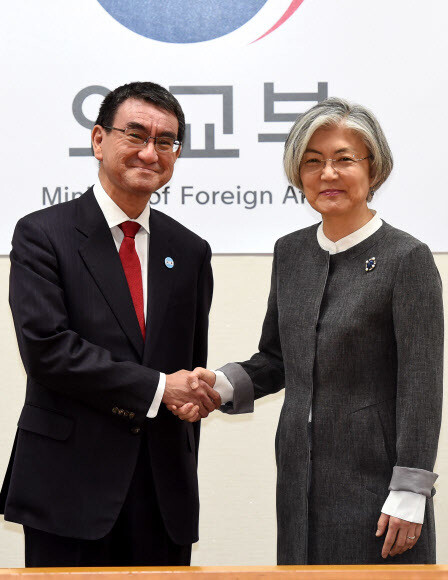 South Korean Foreign Minister Kang Kyung-wha shakes hands with Japanese Foreign Minister Taro Kono prior to their meeting at the Ministry of Foreign Affairs headquarters in Seoul on Apr. 11.