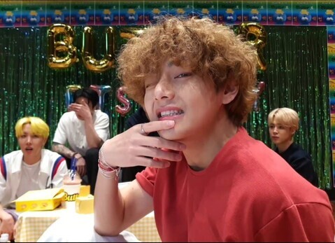 V is pictured with his curly perm. (V Live screenshot)