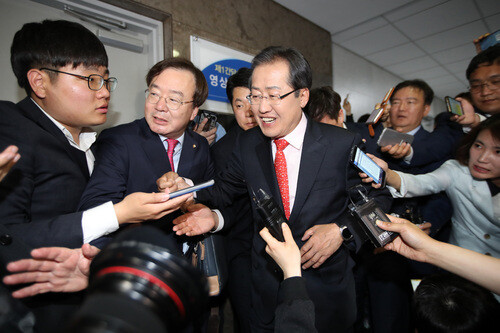 Liberty Korea Party presidential candidate Hong Joon-pyo smiles as he leaves a meeting with Bareun Party lawmakers