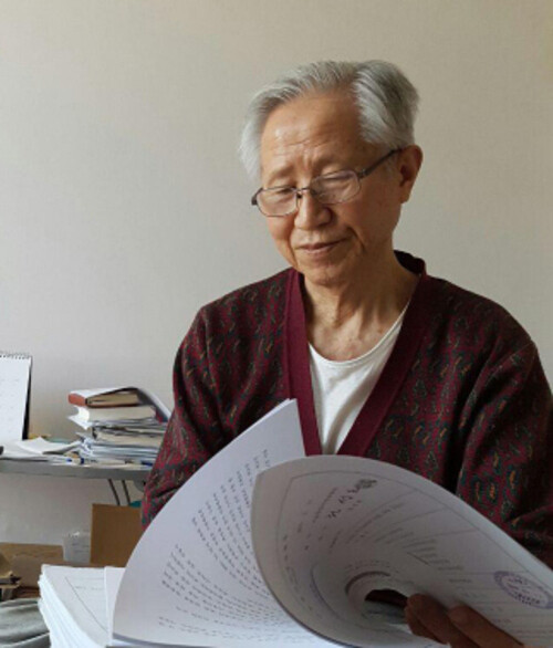 Lee Dae-shik looks through his file at his home in Seoul‘s Sungbok district