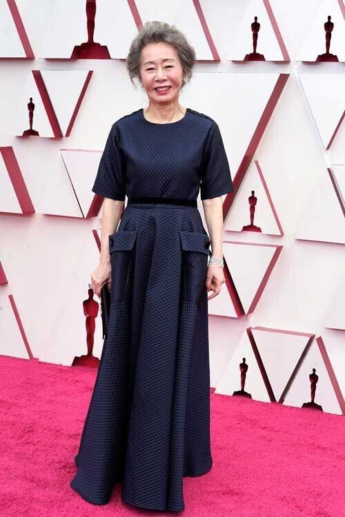 Youn Yuh-jung walks the red carpet as she attends the 93rd Academy Awards on Sunday. (Yonhap News)