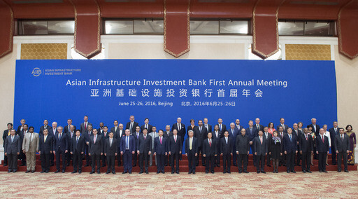 Officials from Asian Infrastructure Investment Bank member countries pose for a commemorative photo at the bank’s first annual conference in Beijing