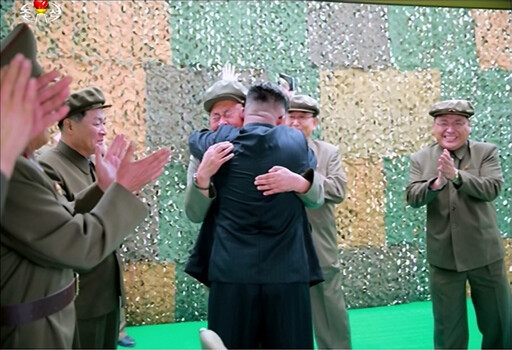 An image from Korean Central Television of North Korean leader Kim Jong-un hugging air force commander Yi Pyong-chol