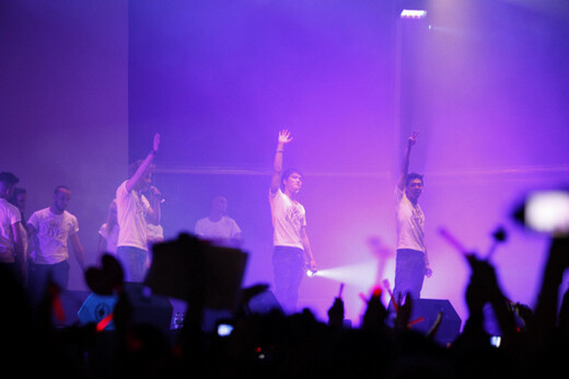 Members of K-pop group JYJ wave as European fans cheer during their concert in Barcelona