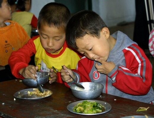  who are having a meal in a kindergarten near Mount Myohang. The photo was taken in 2006.