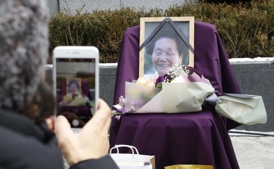 A photo of former comfort woman Song Sin-do is placed alongside flowers at the 1314th demonstration outside the site of the former Japanese embassy in the Jongno District of Seoul on Dec. 20. (by Park Jong-shik
