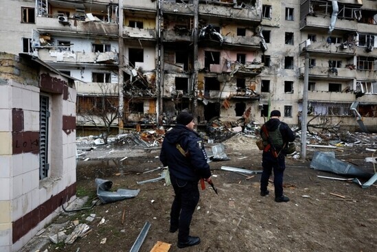 Ukrainian soldiers sweep the ruins of a building that was hit by a Russian missile in the early hours of Feb. 25. (Reuters/Yonhap News)