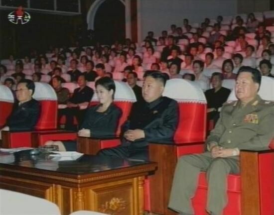 The same unidentified woman sits next to Kim Jong-un as he watches a performance on July 6. The sightings of the woman positioned close to the young North Korean leader has sparked debate over her identity and relation to Kim Jong-un. (Yonhap News) 　