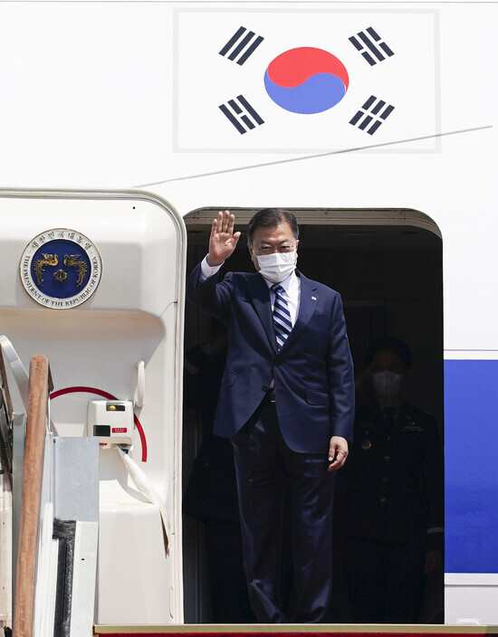 South Korean President Moon Jae-in waves his hand as he boards Code One at Seoul Air Base for his trip to Washington on Wednesday. (Yonhap News)