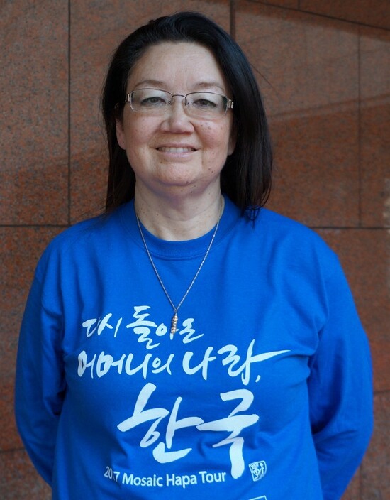 Bella Siegel-Dalton is a mixed-race adoptee who returned to South Korea after 51 years to look for her biological mother’s family. The big Korean letters on her shirt say