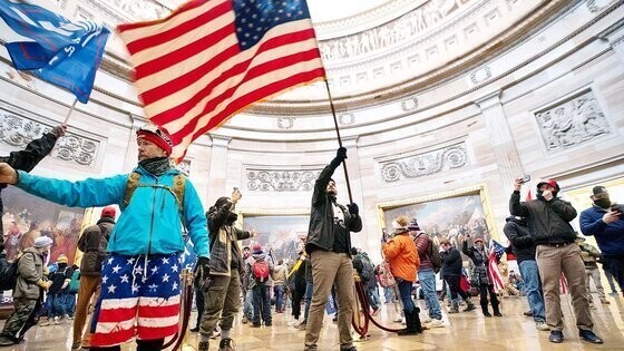 A supporter of Donald Trump waves the American flag after breaking into the Capitol on Jan. 6, 2021. (Yonhap)