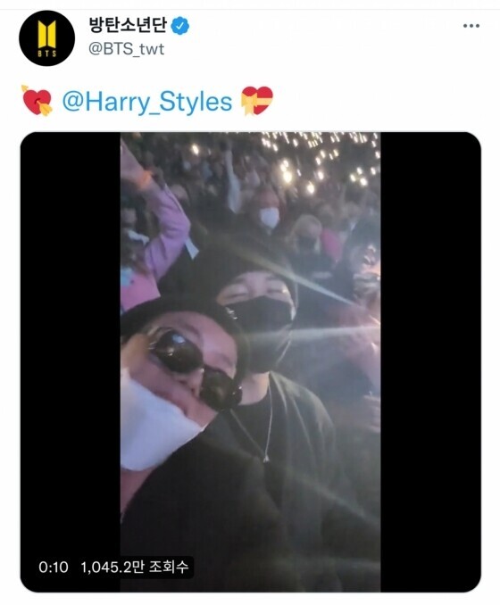BTS in the crowd during a Harry Styles concert. (screen capture from BTS’ Twitter account)