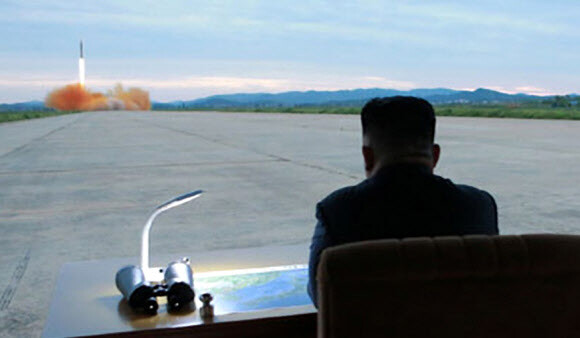 North Korean leader Kim Jong-un observes the launch of the Hwasong-12 IRBM from the airstrip of the Sunan International Airport in Pyongyang on the morning of Aug. 29. (Yonhap News)