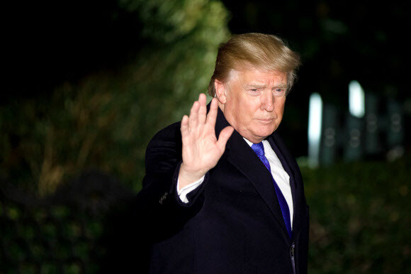 US President Donald Trump waves as he leaves the White House on Jan. 24 to travel to the World Economic Forum being held Davos