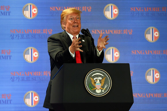 US President Donald Trump speaks at a press conference after his summit with North Korean leader Kim Jong-un on June 12 in Singapore. (AFP/Yonhap News)