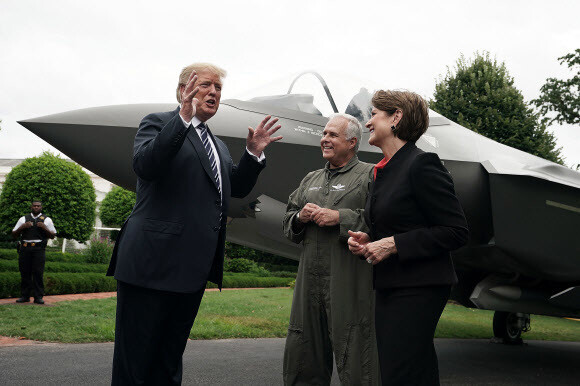 US President Donald Trump speaks with Marillyn Hewson