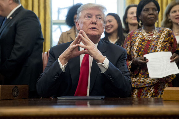 US President Donald Trump talks with reporters after signing the Women‘s Global Development and Prosperity Initiative at the White House on Feb. 7. (AP)