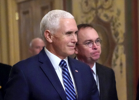 US Vice President Mike Pence (left) and acting White House Chief of Staff Mick Mulvaney arrive at the Capitol Building in Washington