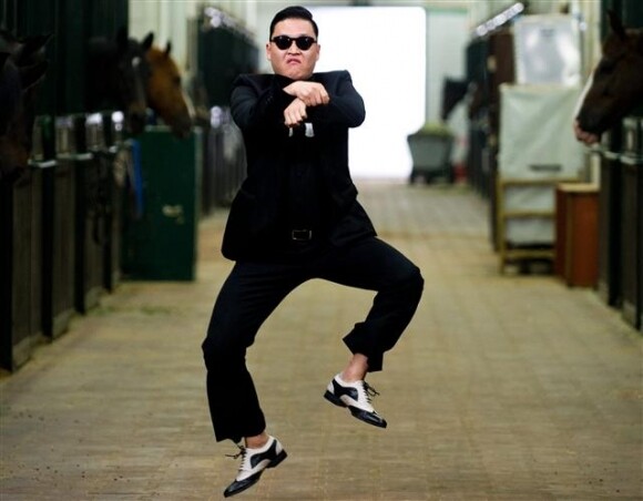 A still from Psy’s “Gangnam Style” video captures him doing his famous “horse dance.”  Psy and 2NE1 will participate in a hologram concert at the World Economic Forum as part of a “Korea night” organized by the Federation of Korean Industries. (YouTube screen capture)