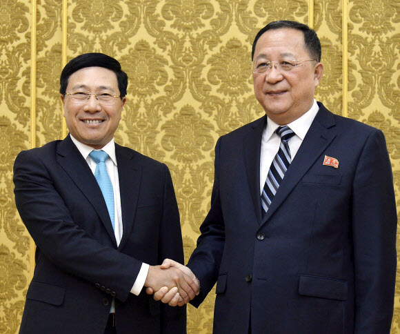 Vietnamese Foreign Minister Pham Binh Minh (left) with North Korean Foreign Minister Ri Yong-ho pose for a photo before a meeting in Pyongyang on Feb. 13. (Kyodo News/AP)