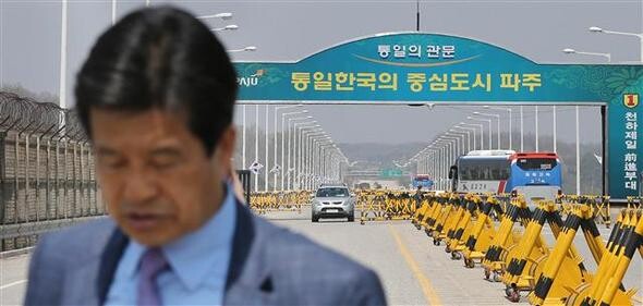  a representative of the Corporate Association of Gaesong Complex looks down at the ground on the south side of the Unification Bridge that leads to the Kaesong Industrial Complex from Paju