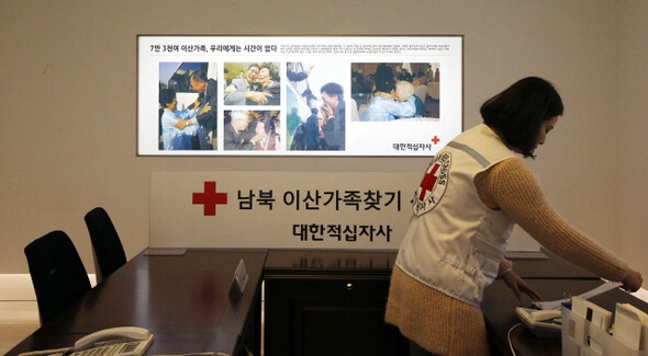  a staff member looks at a work document on the reception desk where members of divided families seeking reunions with their relatives in North Korea register for possible reunions at the Korean Red Cross offices in central Seoul