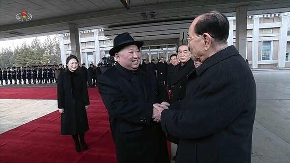 North Korean leader Kim Jong-un shakes hands with Kim Yong-nam