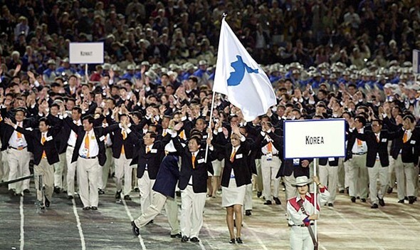 The South and North Korean athletic delegations make their first unified joint entrance at the Sydney Olympic Games in 2000. (Photo Pool)