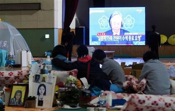Families of those who died in the Sewol tragedy cry in front of Gwangju District Court after the verdict was announced