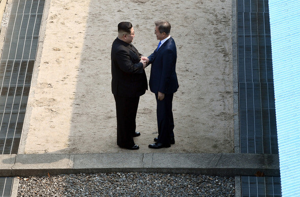 South Korean President Moon Jae-in shakes hands with North Korean leader Kim Jong-un in front of the Military Demarcation Line in the Panmunjeom Joint Security Area on Apr. 27. (by Kim Kyung-ho