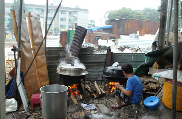 지난 8월12일 새벽 강남구청 직원과 철거용역 140여 명이 서울 강남 포이동 재건마을에 난입했다. 6월 화재 뒤 노인가구를 위해 만든 가건물은 그들의 손에 의해 흔적도 없이 사라졌다. 8월17일 마을회관에서는 마을 주민들을 위한 식사 준비가 한창이었다. 그 너머로 폐허가 된 재건마을의 빈터가 보인다. 한겨레21 이종찬 선임기자