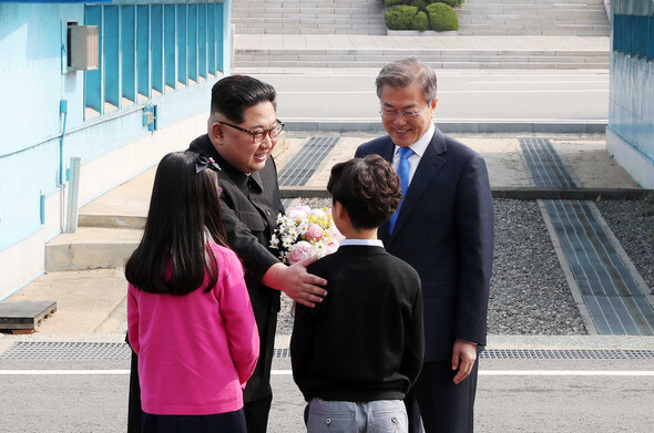  South Korean President Moon Jae-in and North Korean leader Kim Jong-un cross the Military Demarcation Line together entering the North Korean side during their summit on Apr. 27. (by Kim Kyung-ho