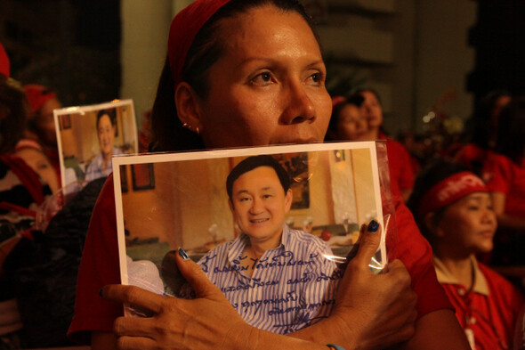 시위는 야간에도 이어졌다. 탁신 친나왓 전 총리의 사진을 가슴에 안은 한 여성이 시위 지도부의 연설을 듣고 있다.