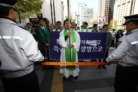 4월29일 오후 서울 중구 성공회 대성당에서 ‘4대강 지키기 연합예배’가 끝난 뒤, 목회자와 신도들이 서울광장으로 행진하고 있다. 경찰의 제지로 펼침막의 ‘4대강’ 부분을 헝겊으로 가렸다. 한겨레21 류우종 기자