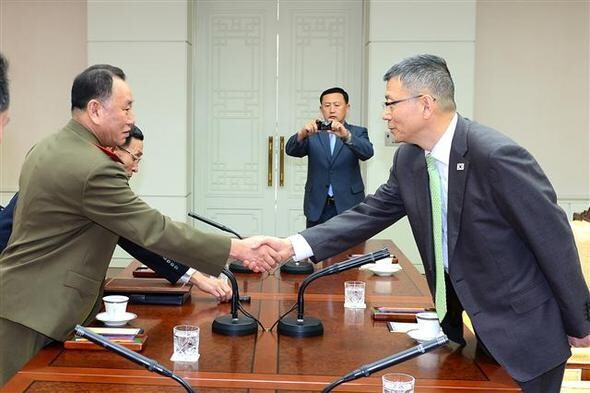  shakes hands with Kim Yong-chol