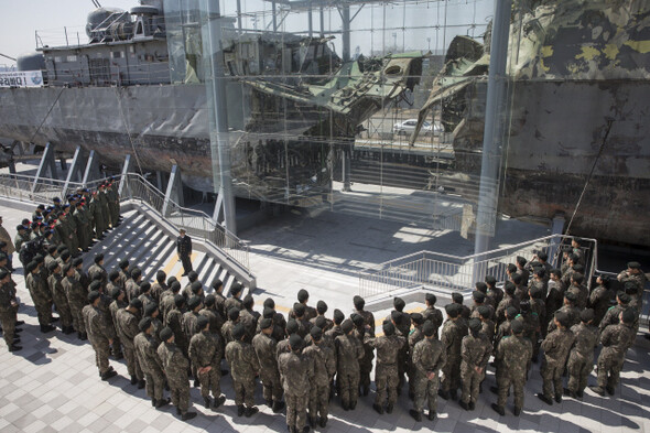  South Korean soldiers look at the salvaged warship where it is exhibited at the yard of the Second Fleet Command in Pyeongtaek