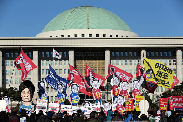 Members of labor unions hold a press conference in front of the National Assembly in Seoul