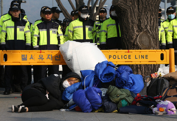 Students sleep on the street outside the Central Government Complex in Seoul
