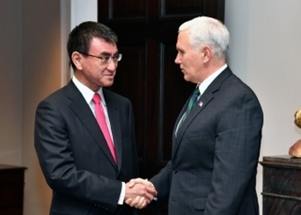 Japanese Foreign Minister Taro Kono shakes hands with US Vice President Mike Pence during his visit to Washington