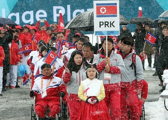 The North Korean delegation is shown taking part at the welcoming ceremony for the Pyeongchang Paralympic Athletes Village